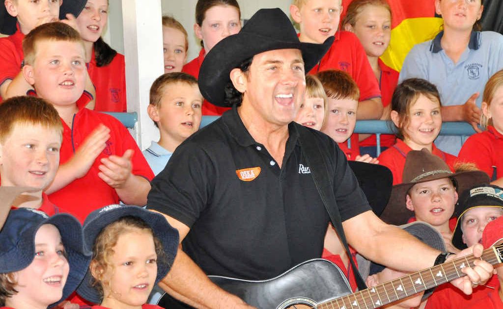 Country singer Lee Kernaghan belts out The Boys From The Bush with Rolleston school children yesterday. Country singer Lee Kernaghan belts out The Boys From The Bush with Rolleston school children yesterday.
